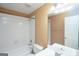 Clean bathroom with white tile, single vanity, and a shower-tub combination at 12043 Olmstead Dr, Fayetteville, GA 30215