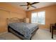 Bedroom with neutral carpet, bed, dresser and natural light in an orange color scheme at 12043 Olmstead Dr, Fayetteville, GA 30215