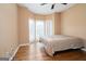 Bedroom with a bay window, hardwood floors, and neutral color scheme, offering a calm and inviting atmosphere at 12043 Olmstead Dr, Fayetteville, GA 30215