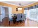 Formal dining area with hardwood floors and a table set for six, perfect for entertaining guests at 12043 Olmstead Dr, Fayetteville, GA 30215