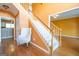 Welcoming foyer with hardwood floors, staircase, and view into adjacent living spaces at 12043 Olmstead Dr, Fayetteville, GA 30215