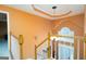 Foyer featuring stairs, white railings, a chandelier, and natural light in an orange color scheme at 12043 Olmstead Dr, Fayetteville, GA 30215