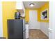 Cozy kitchen features yellow walls, white cabinets, and compact appliances, perfect for efficient meal preparation at 12043 Olmstead Dr, Fayetteville, GA 30215