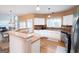 The kitchen showcases an open layout with stainless appliances and eat-in bar area at 12043 Olmstead Dr, Fayetteville, GA 30215