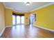 Sun-filled living room with hardwood floors, bay window, and view of the entry foyer at 12043 Olmstead Dr, Fayetteville, GA 30215