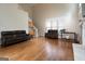 Open living room featuring hardwood floors, a staircase, and ample natural light at 12043 Olmstead Dr, Fayetteville, GA 30215