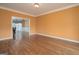 Spacious living room featuring hardwood floors and view into the adjacent dining room at 12043 Olmstead Dr, Fayetteville, GA 30215