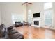 Bright living room with a cozy fireplace, a ceiling fan, and large windows for ample light at 12043 Olmstead Dr, Fayetteville, GA 30215