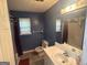 Bathroom with a single sink vanity, toilet, and shower/tub at 4514 Tifton Ct, Powder Springs, GA 30127