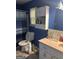 Bathroom with a window, toilet, sink, and vanity at 4514 Tifton Ct, Powder Springs, GA 30127