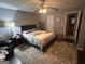Main bedroom with a ceiling fan, bed, and a decorative rug at 4514 Tifton Ct, Powder Springs, GA 30127