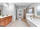 Open bathroom with a neutral tile shower, soaking tub, and vanity at 360 Grandmas Ln, Fayetteville, GA 30215