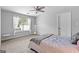 A bright bedroom with carpet, a window, and a bed with gray covers at 360 Grandmas Ln, Fayetteville, GA 30215