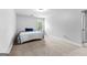 A bright bedroom with carpet, a window, and a bed with blue and white covers at 360 Grandmas Ln, Fayetteville, GA 30215