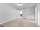 Neutral bedroom with neutral carpet and an open door, revealing an open space at 360 Grandmas Ln, Fayetteville, GA 30215