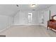 Expansive bonus room with neutral carpet and multiple access doors at 360 Grandmas Ln, Fayetteville, GA 30215
