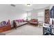 Bright bonus room with comfortable seating, neutral carpet, and built-in shelving for entertainment at 360 Grandmas Ln, Fayetteville, GA 30215