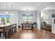 Open dining room with a farmhouse table and chairs, and a view to the living room at 360 Grandmas Ln, Fayetteville, GA 30215
