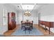 Elegant dining room featuring a coffered ceiling, wood floors, and stylish furniture at 360 Grandmas Ln, Fayetteville, GA 30215