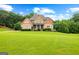 Charming two-story home with stone accents, a welcoming front porch, and a lush green lawn at 360 Grandmas Ln, Fayetteville, GA 30215