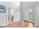 Airy foyer with wood-look floors and neutral walls leading to various rooms and featuring a glass-paneled door at 360 Grandmas Ln, Fayetteville, GA 30215