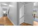 Hallway with a staircase, wood floors, and a view to a sitting room at 360 Grandmas Ln, Fayetteville, GA 30215