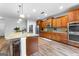 Well-equipped kitchen with stainless steel appliances, central island, and wooden cabinetry at 360 Grandmas Ln, Fayetteville, GA 30215