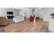 Living room with a large couch, TV, and wood floors that extend into the hallway at 360 Grandmas Ln, Fayetteville, GA 30215