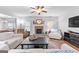 Inviting living room boasting a stone fireplace, ceiling fan, and plush seating at 360 Grandmas Ln, Fayetteville, GA 30215