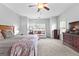 Main bedroom featuring a bed, dresser, windows, and carpeted flooring at 360 Grandmas Ln, Fayetteville, GA 30215