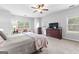 Main bedroom with carpet, a dresser, and a seating area by the window at 360 Grandmas Ln, Fayetteville, GA 30215