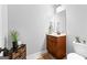 Cozy powder room with wood vanity, decorative mirror, toilet, and stylish decor at 360 Grandmas Ln, Fayetteville, GA 30215