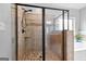 Neutral tile shower with black hardware and seamless glass door at 360 Grandmas Ln, Fayetteville, GA 30215