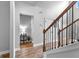 Staircase with wood and wrought iron railing, hallway, and view to other rooms at 360 Grandmas Ln, Fayetteville, GA 30215