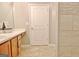 Bathroom featuring wood cabinets, tile flooring, and shower with decorative tile at 131 Meadowbrook Ln, Grantville, GA 30220