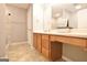 Bathroom featuring wood cabinets, tile flooring, and shower with decorative tile at 131 Meadowbrook Ln, Grantville, GA 30220