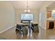 Bright dining space with a wooden table set, light fixture, and hardwood flooring at 131 Meadowbrook Ln, Grantville, GA 30220