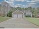 Inviting single-Gathering home featuring a two-car garage, stone accents, manicured lawn and mature trees at 131 Meadowbrook Ln, Grantville, GA 30220