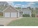 Charming single-Gathering home with stone accents, vinyl siding, attached garage, and well-maintained landscaping at 131 Meadowbrook Ln, Grantville, GA 30220