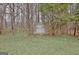 The backyard features a storage shed surrounded by trees at 131 Meadowbrook Ln, Grantville, GA 30220
