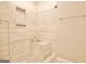 Shower featuring decorative tile, built in storage niches, and a shower bench at 131 Meadowbrook Ln, Grantville, GA 30220