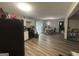 Efficient kitchen layout with black appliances, white cabinetry, and dining area with natural light at 3885 Morning Creek Dr, South Fulton, GA 30349