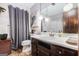 Bathroom with a vanity, toilet, mirror, and gray shower curtain at 6230 S Summers Cir, Douglasville, GA 30135