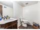 Bathroom with dark wood vanity with marble countertop and modern toilet at 6230 S Summers Cir, Douglasville, GA 30135