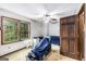 Bedroom with window, ceiling fan, and wood door at 6230 S Summers Cir, Douglasville, GA 30135
