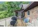 Exterior deck with grill and seating, overlooking wooded backyard at 6230 S Summers Cir, Douglasville, GA 30135