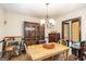 Traditional dining room featuring a wooden table, chandelier, and ample storage with a china cabinet at 6230 S Summers Cir, Douglasville, GA 30135