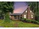 Charming brick home featuring a covered porch and well-maintained landscaping with mature trees at 6230 S Summers Cir, Douglasville, GA 30135