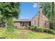 Charming brick home featuring a covered porch and well-maintained landscaping with mature trees at 6230 S Summers Cir, Douglasville, GA 30135