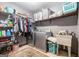 Functional laundry room with washer, dryer, shelving, and storage baskets at 6230 S Summers Cir, Douglasville, GA 30135